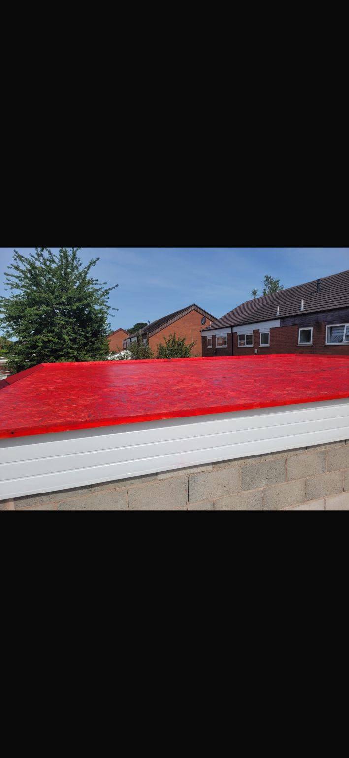 Completed domestic flat roof with a red finish