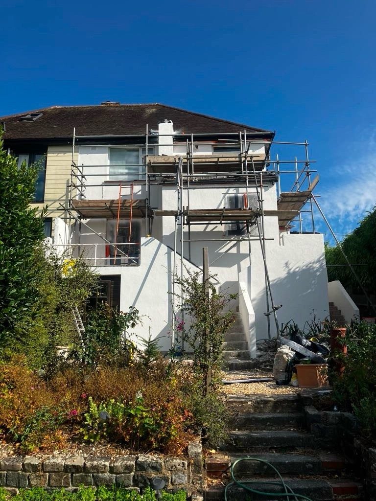 Scaffolded house finished in fresh white render
