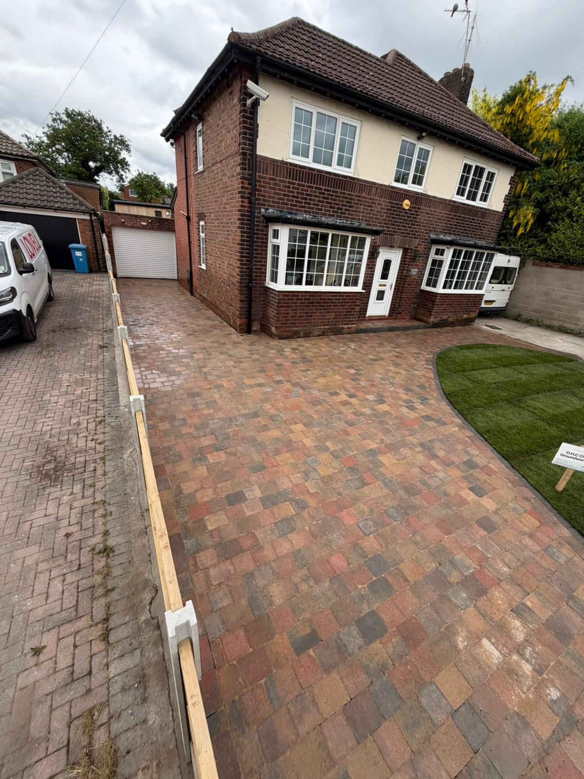 96 sqm Heather Trio Tegula driveway, charcoal kerbs, new turf