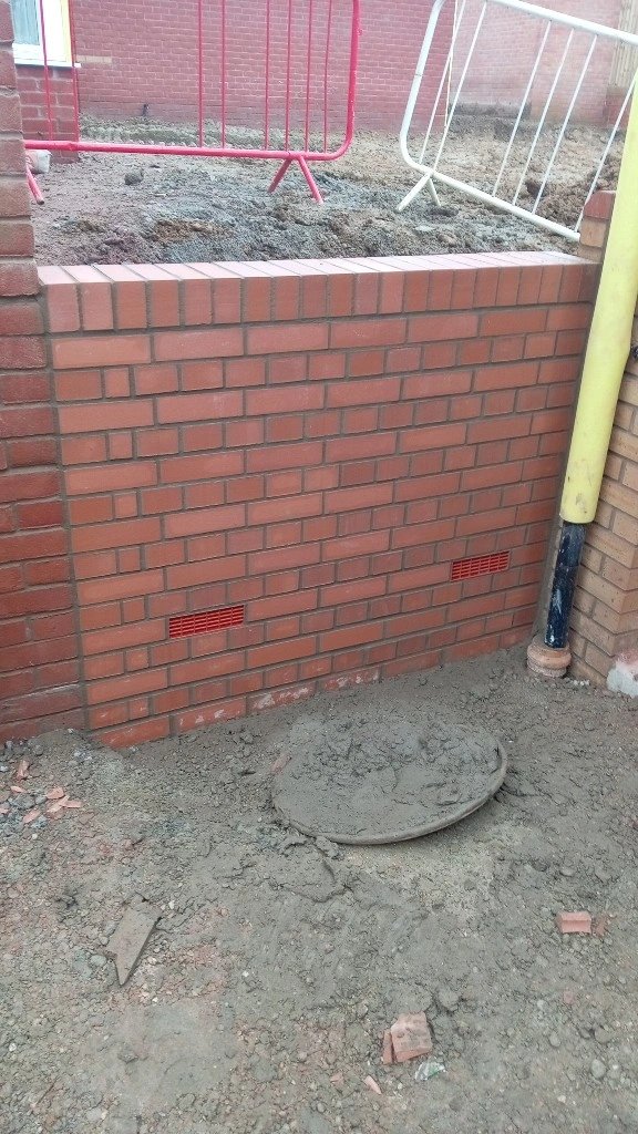 New red brick pier and wall on a building site