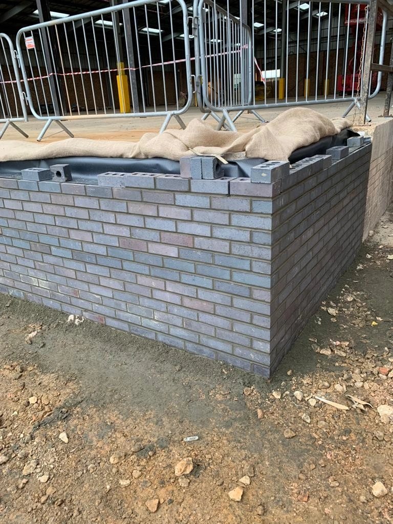Blue-grey engineering brick retaining wall