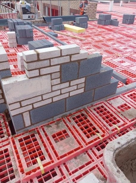 Blockwork rising off a beam-and-block floor on site