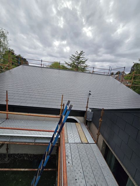 Wide slate roof with scaffold