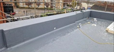 Large single ply flat roof with parapet upstands