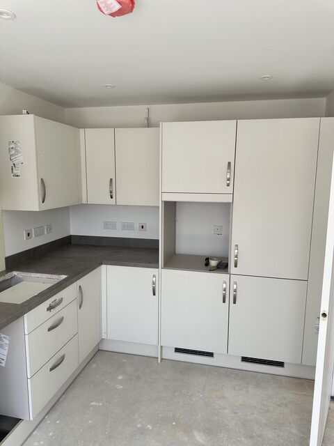 Cream kitchen with tall units and a run of base cabinets