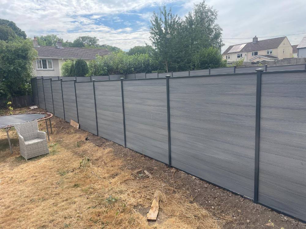 Grey composite panel fencing along a rear boundary
