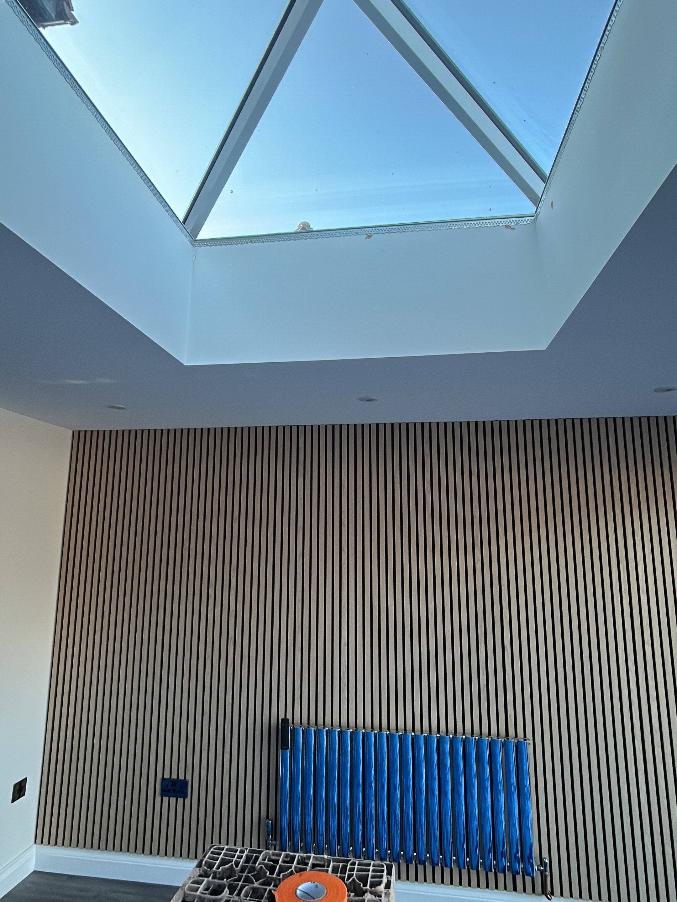 Finished ceiling with a skylight and a slat wall