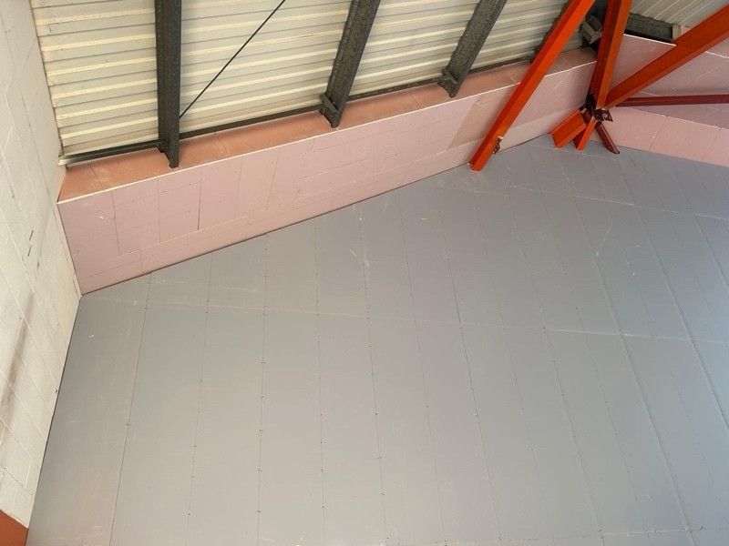 Boarded wall and ceiling against a steel frame