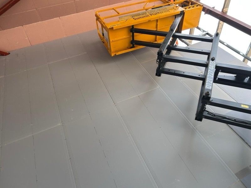 Metal stud track set out across a floor