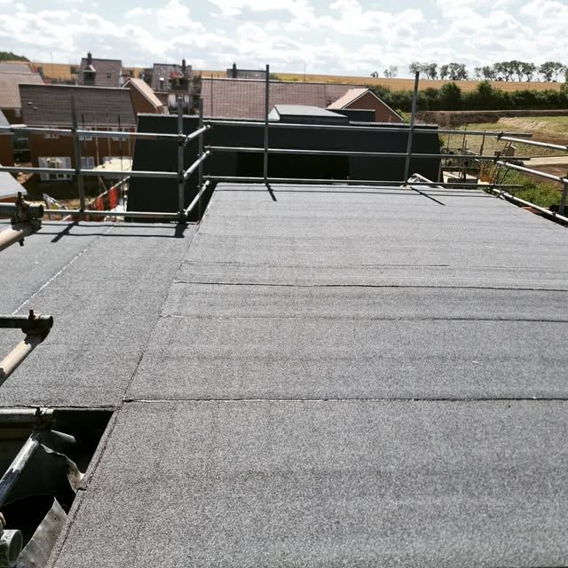 Completed torch-on felt flat roof with edge protection
