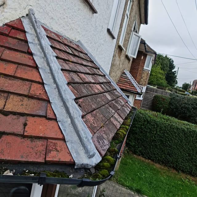 Pitched tiled roof with ridge and leadwork