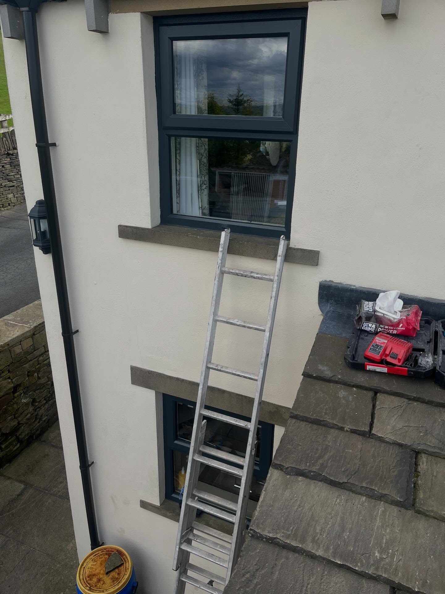 Exterior uPVC window spraying job on a rendered house
