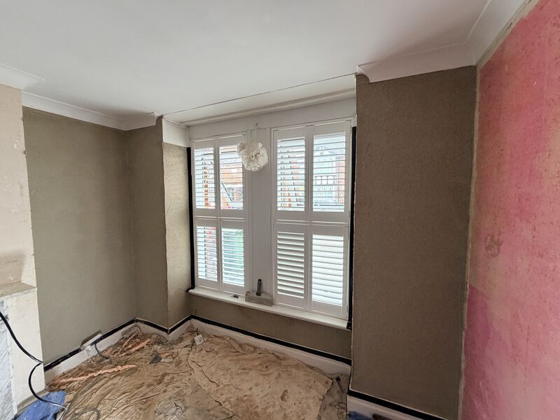 Cork insulation applied to a bay window wall