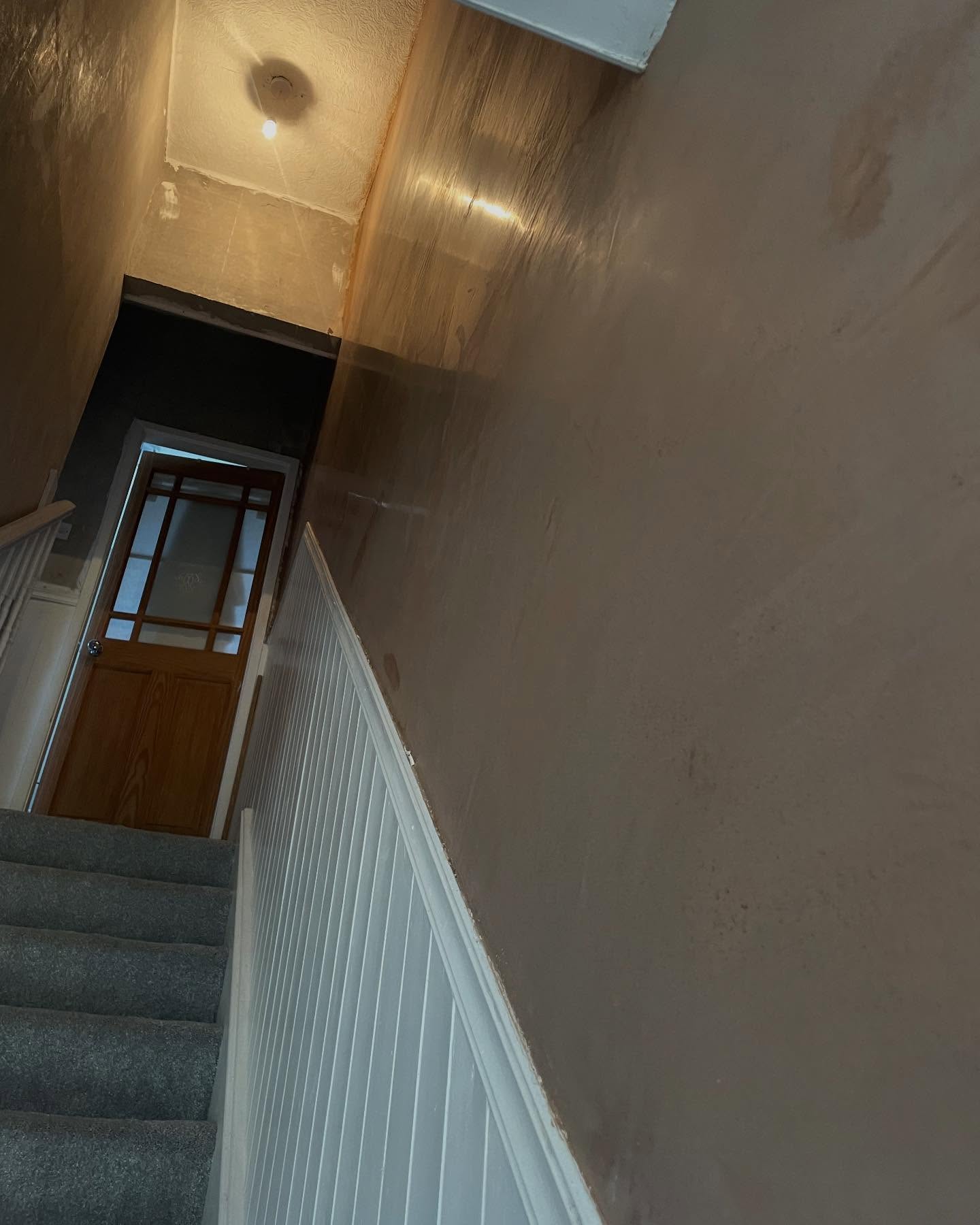 Stairwell freshly skimmed over panelling by Silko Plastering Solutions