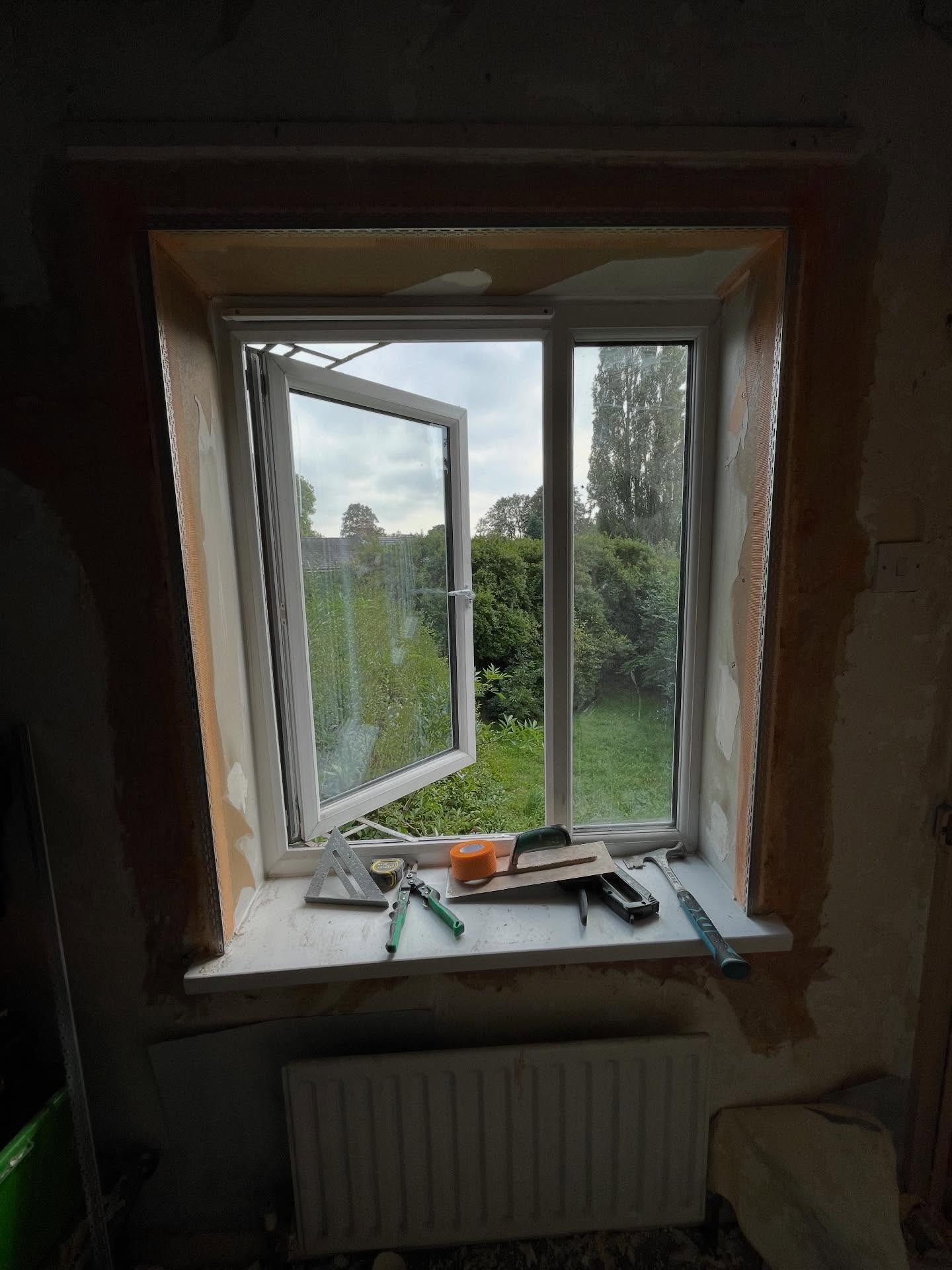 Window reveal and surrounding wall freshly re-skimmed