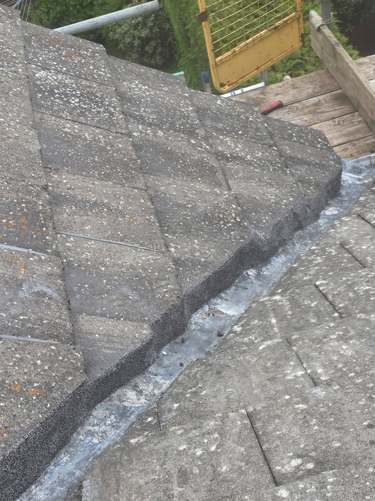 Close-up of a completed verge and valley lead repair on a tiled roof